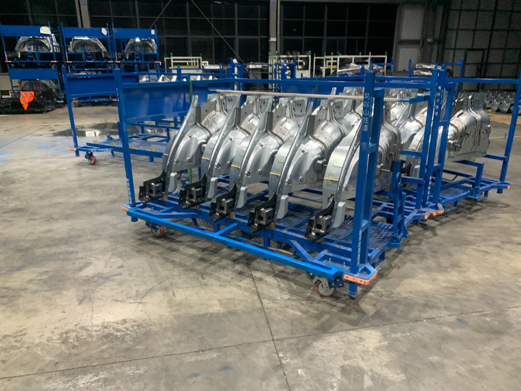 Custom blue turnover racks loaded with automotive body panel assemblies in China OEM stamping factory